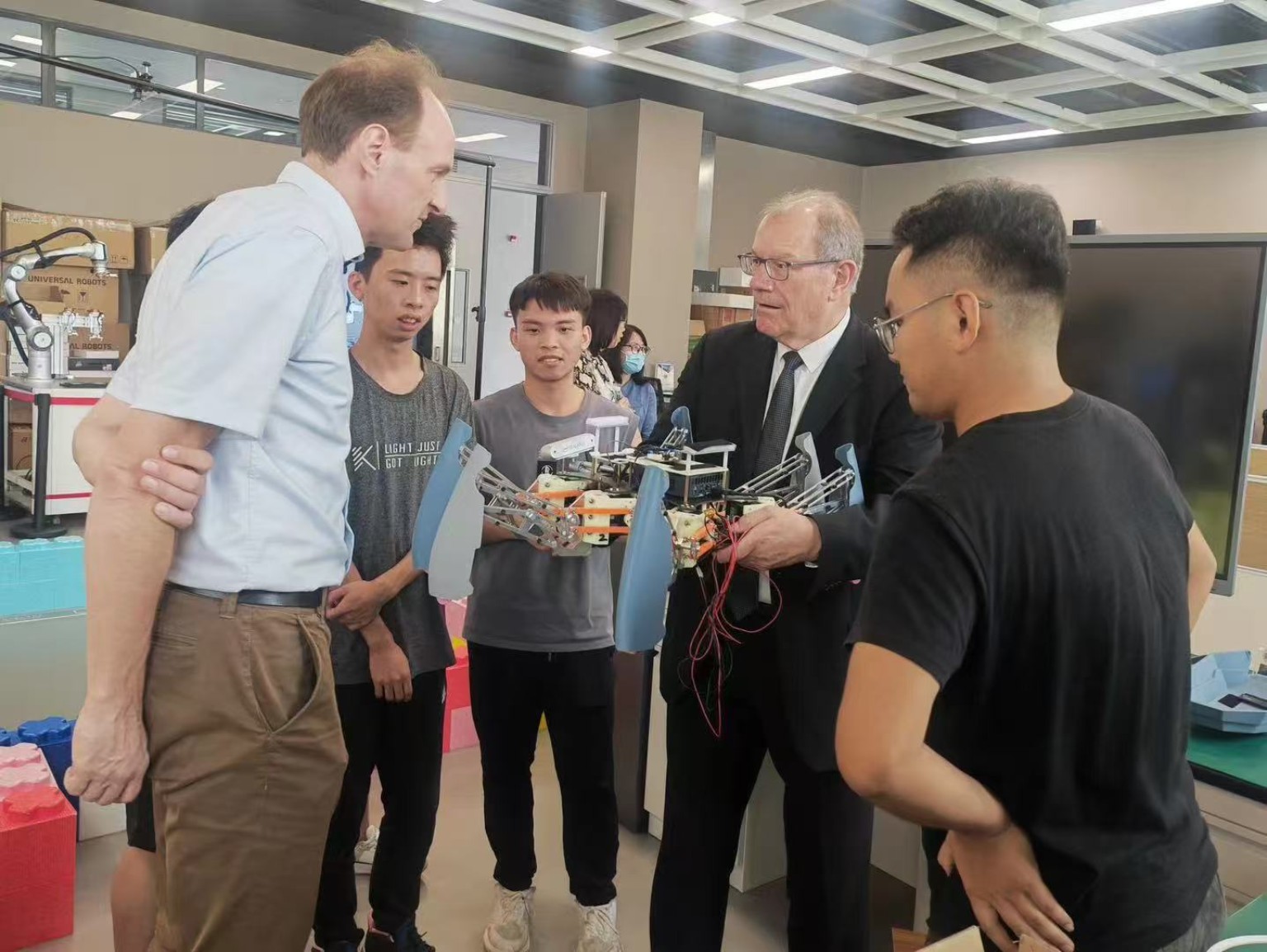 Visitors discussing a robotics research platform