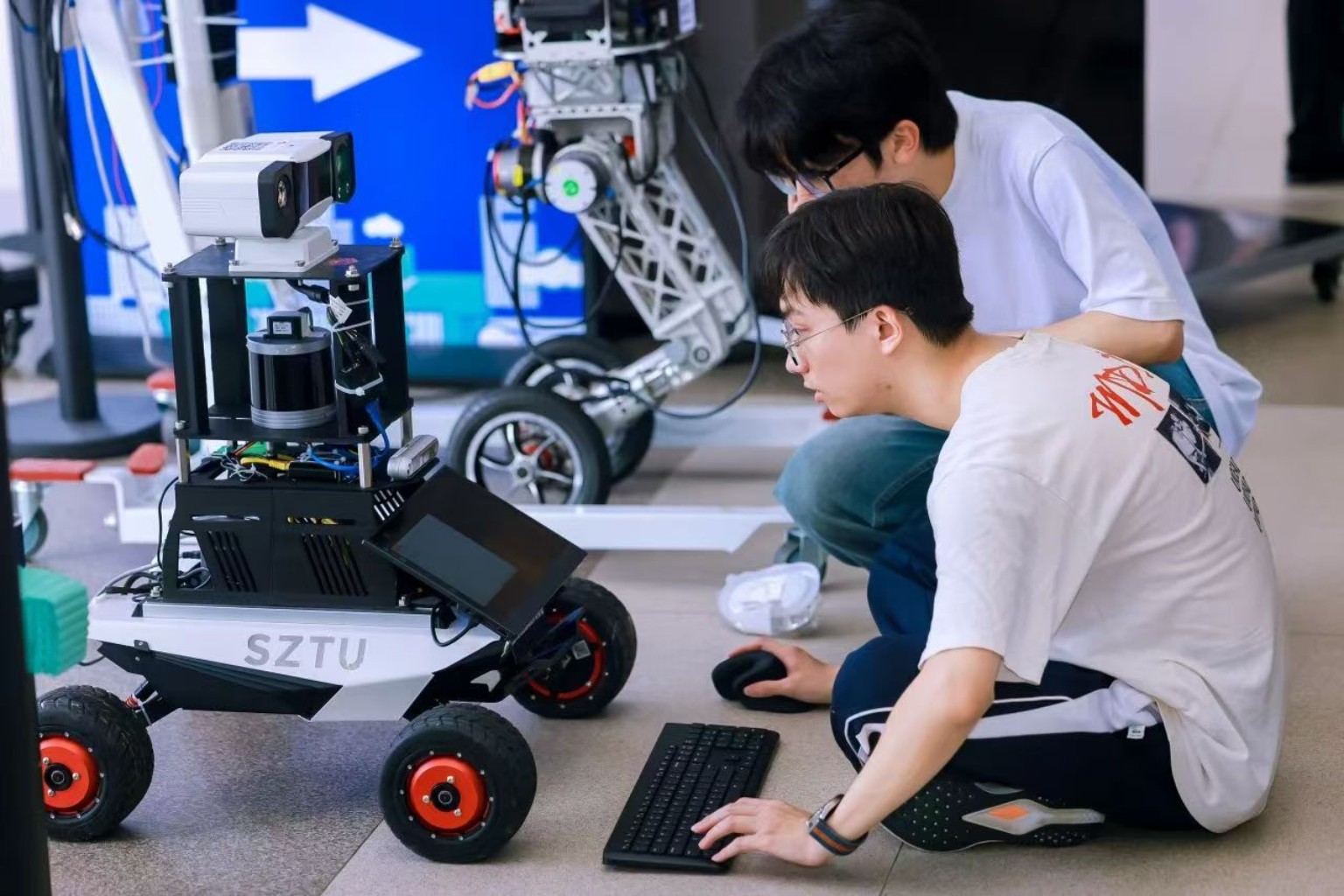 Laboratory members debugging a wheeled mobile robot