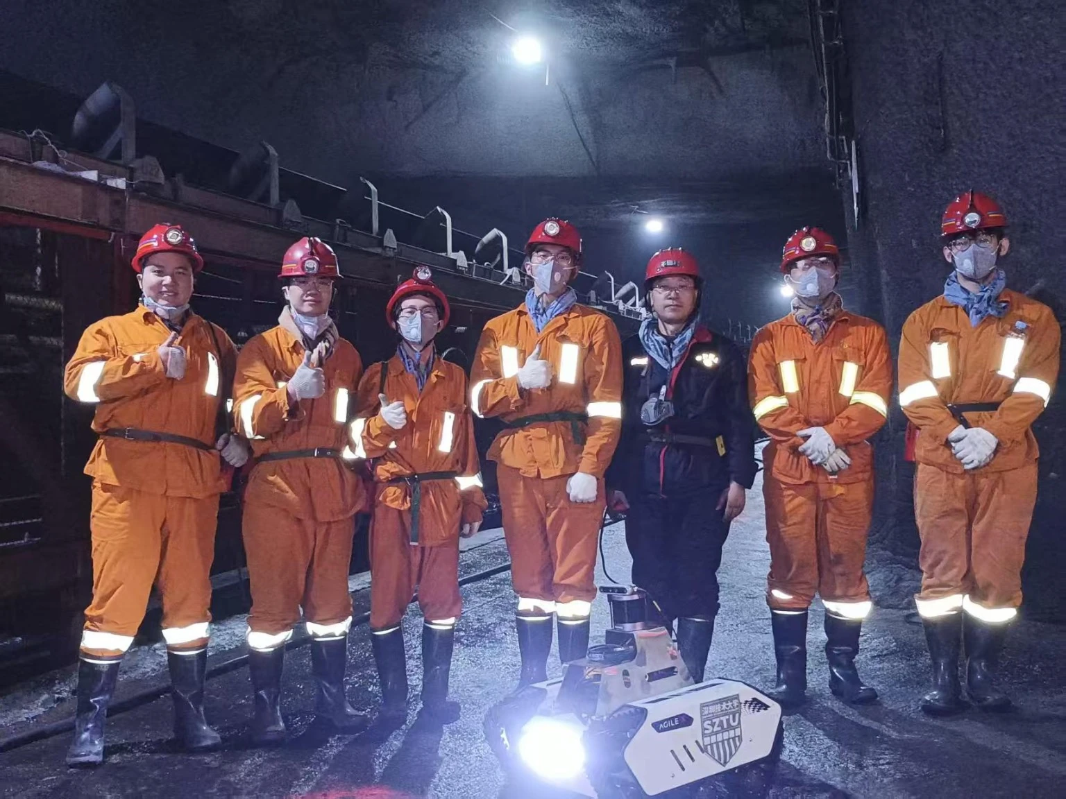 The research team with an earlier tracked validation platform at an underground mine